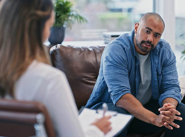 Man speaking with a counselor