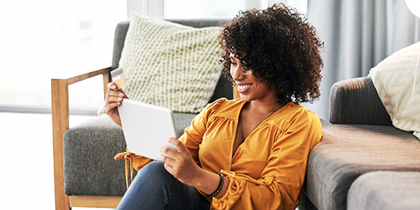 Woman smiling while estimating the cost of her healthcare plan