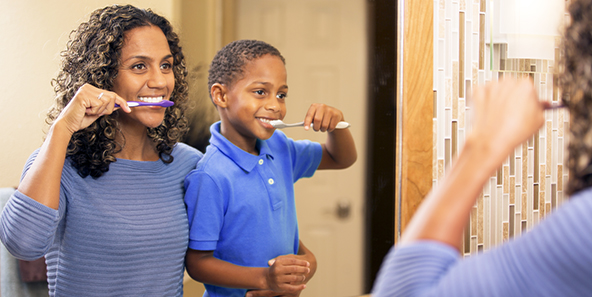 Dental Policy Owners Smiling While Brushing Teeth