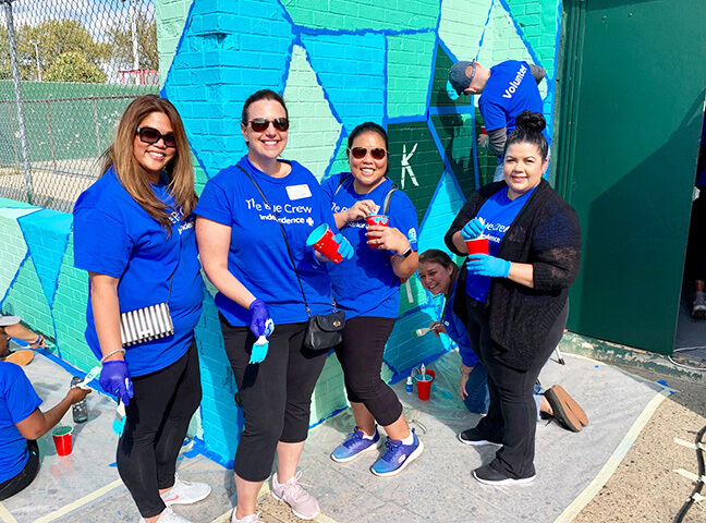 The Blue Crew is working on a mural painting.