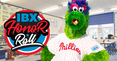 The Philadelphia Phillies mascot - the Phanatic - is standing in a classroom.