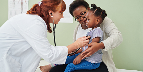 Young Girl Listens To A Doctor's Heart With A Stethoscope During Her Annual Exam