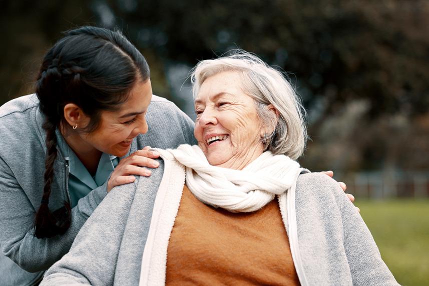 Two women smiling at eachother.