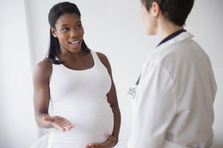 Pregnant woman talking with her doctor