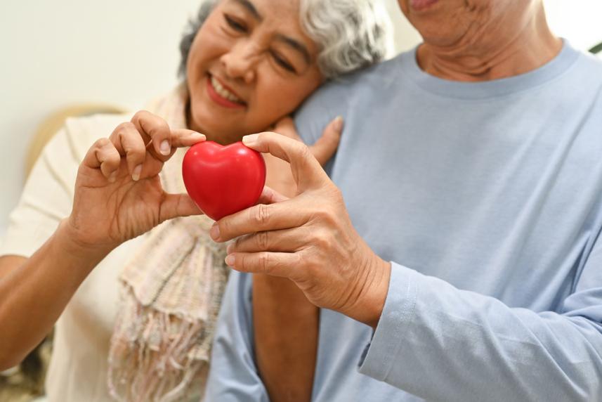 Man and woman holding a heart.