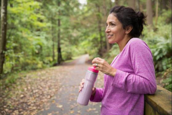 A women outdoors with a water bottle