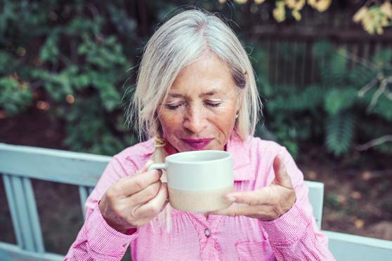 Woman sipping a warm beverage.