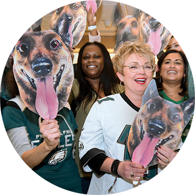 People At A Sporting Event With Dog Masks