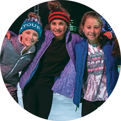 Sisters Ice Skating While Smiling