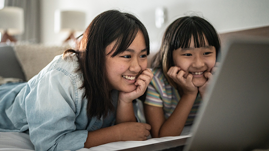 A mother and daughter watch a show together.