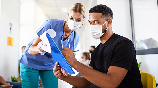 Patient filling out paperwork in doctor's office