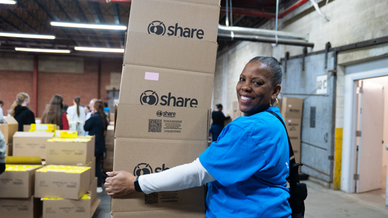 Volunteers pack food boxes.