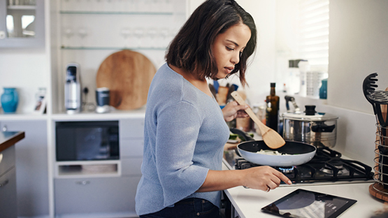 Woman Cooking To Improve Health And Well-being