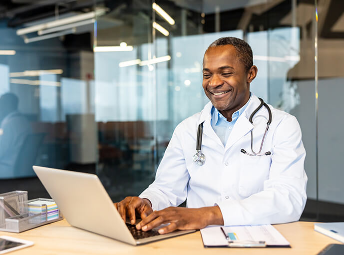 A doctor working on his laptop